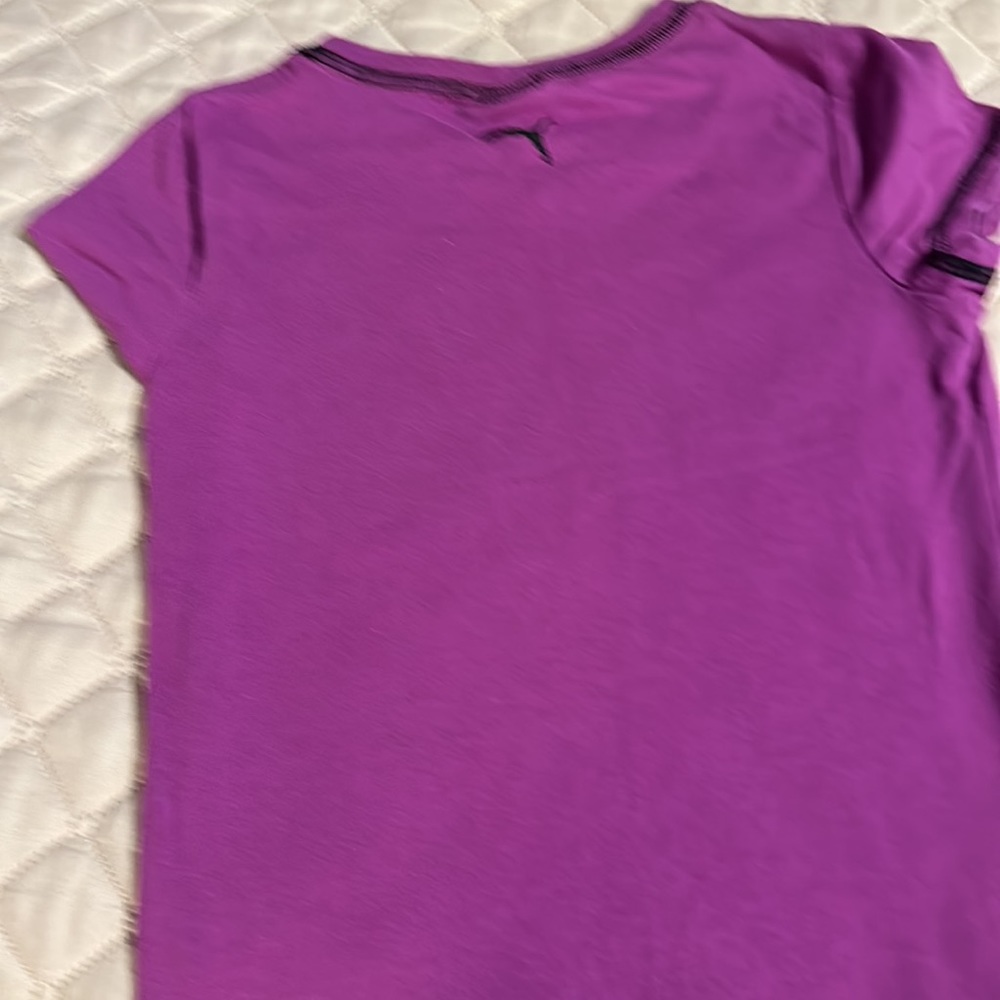 2 tee shirts and pair of shorts shirts are size girls medium. Puma and peanuts. - Picture 10 of 11